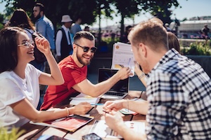 laughing-colleagues-analysing-charts-in-cafe-2026-01-09-07-58-27-utc